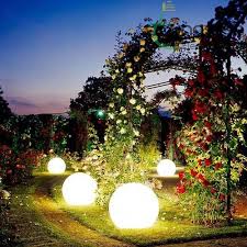 Landscape lighting illuminating a garden at night.