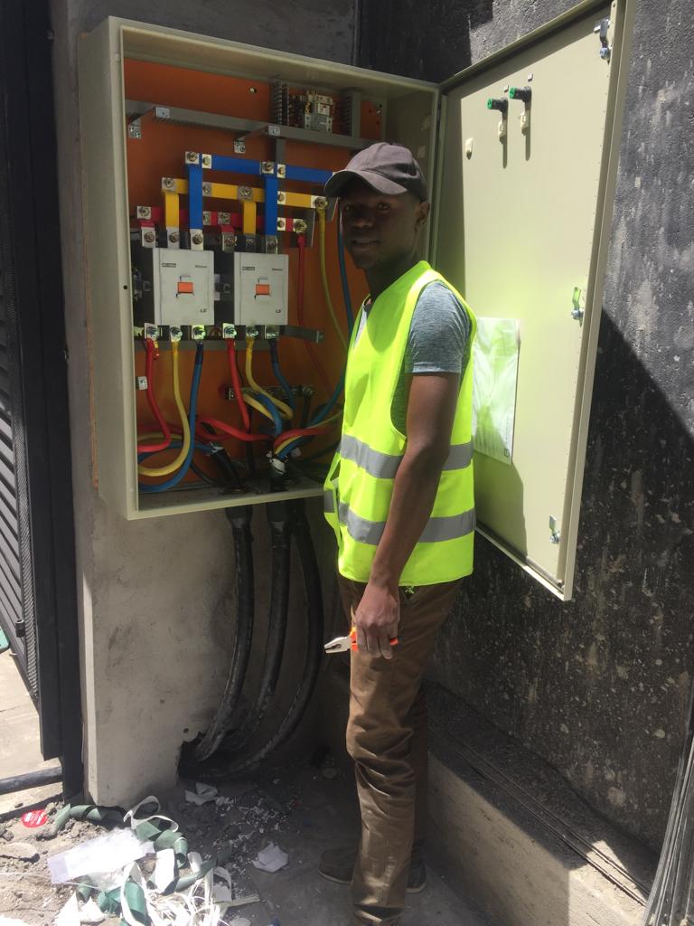 Technician working on an electrical unit box installation.